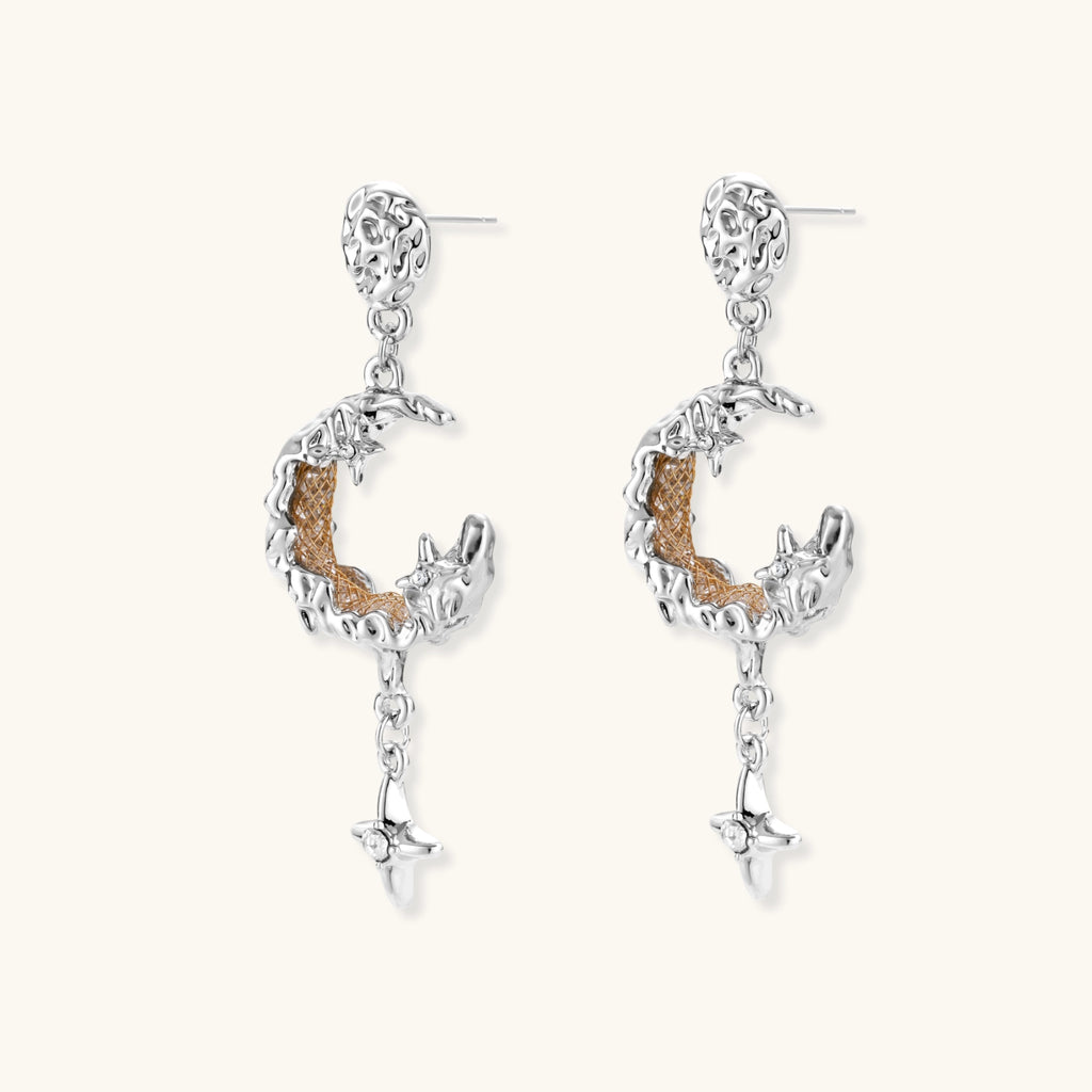 Detailed eco-brass dangle earrings featuring crescent moons with gold rope details and dangling star charms on white background.