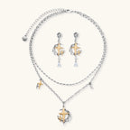 Delicate eco-brass jewelry set featuring gold star and silver moon crescents with clear zirconia crystal drops on cream background