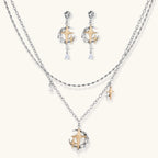 Delicate eco-brass jewelry set featuring gold star and silver moon crescents with clear zirconia crystal drops on cream background