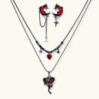 Gothic jewelry set with asymmetrical black metal earrings featuring red crescent moons, stars, and layered necklaces with heart pendants