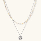 Complete jewelry set featuring citrine stone chips, silver beads, and cosmic circle pendants on cream background.