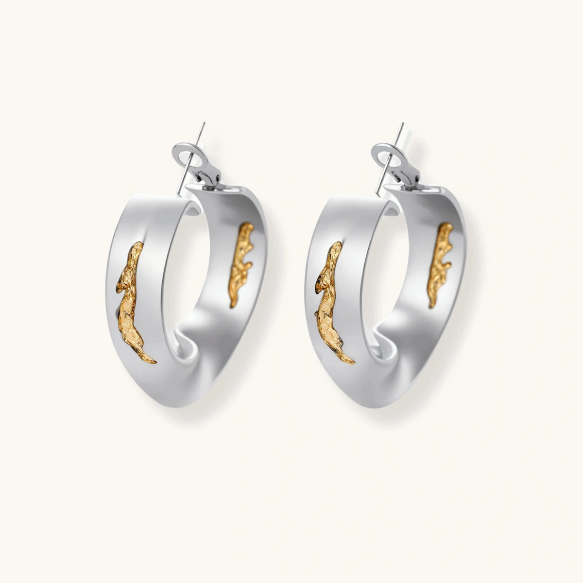 Artistic jewelry set featuring curved silver pendant with gold veining on black cord plus matching asymmetrical hoop earrings