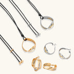 Gold circular pendant necklace with crystals on black cord paired with matching geometric hoop earrings on white background.