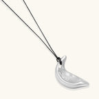 Adjustable crescent moon pendant necklace in gold and silver eco-zinc alloy with decorative engravings on black cord