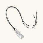 Adjustable black cord necklace with intricate silver-toned pendant featuring ornamental relief patterns and bead details.