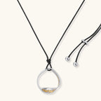 Minimalist silver and gold circle pendant on black adjustable cord, featuring eco-friendly zinc alloy construction