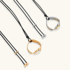 Minimalist silver and gold circle pendant on black adjustable cord, featuring eco-friendly zinc alloy construction