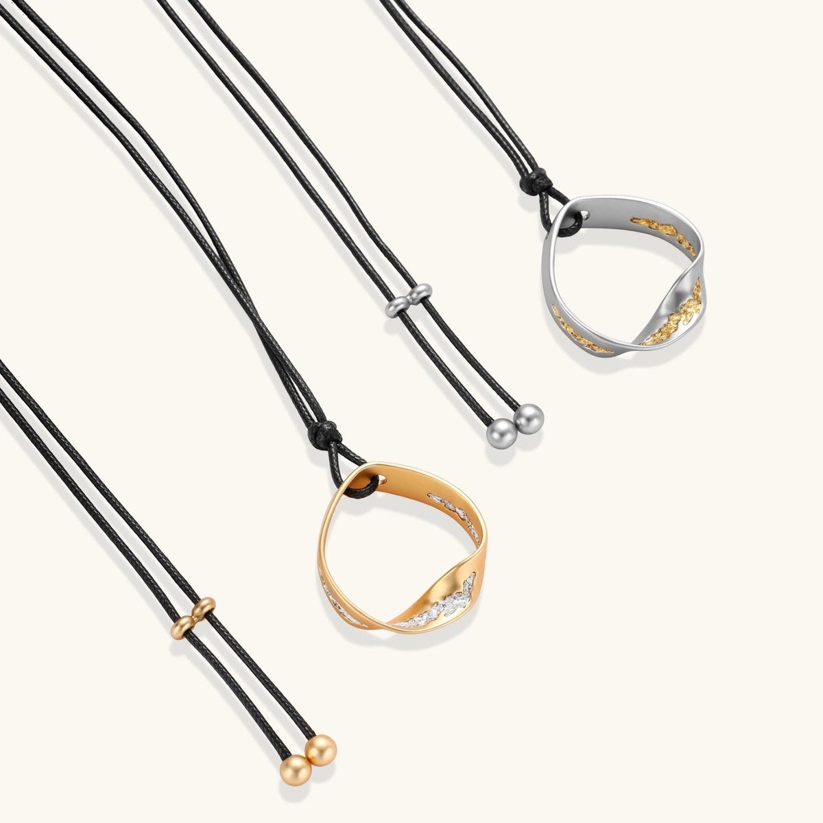 Minimalist silver and gold circle pendant on black adjustable cord, featuring eco-friendly zinc alloy construction