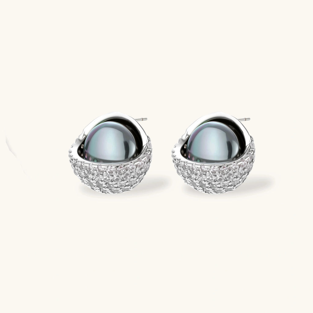 Silver gray Tahitian-style pearl pendant necklace and matching pave zirconia stud earrings set on cream background.