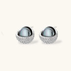 Silver gray Tahitian-style pearl pendant necklace and matching pave zirconia stud earrings set on cream background.