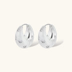 Silver-plated hoop earrings with star cutout designs, shown open and closed on white background, 17mm diameter.