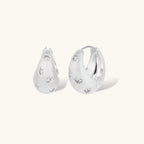 Silver-plated hoop earrings with star cutout designs, shown open and closed on white background, 17mm diameter.