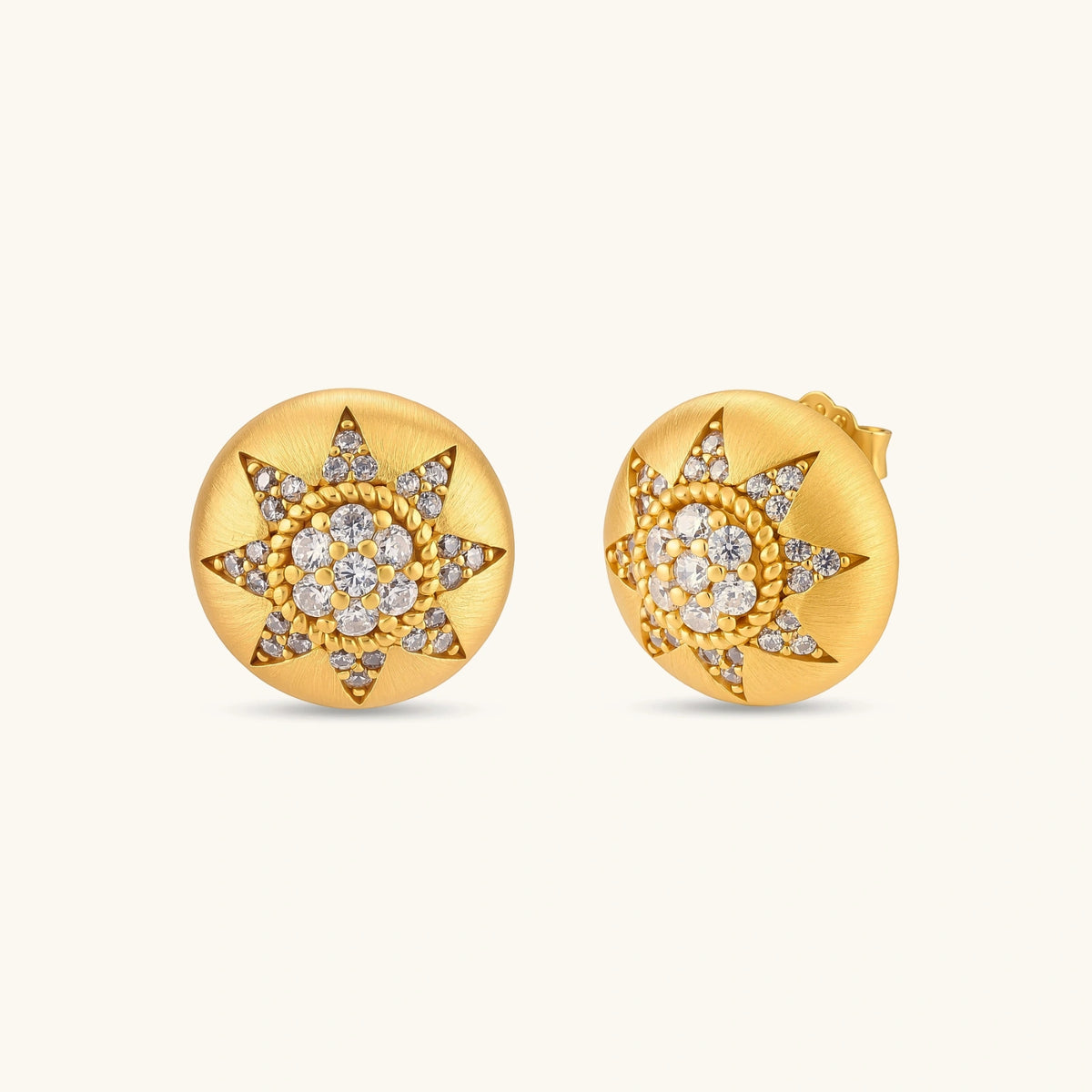 Round domed gold-plated stud earrings with brushed finish and an 8-point star paved in cubic zirconia stones.