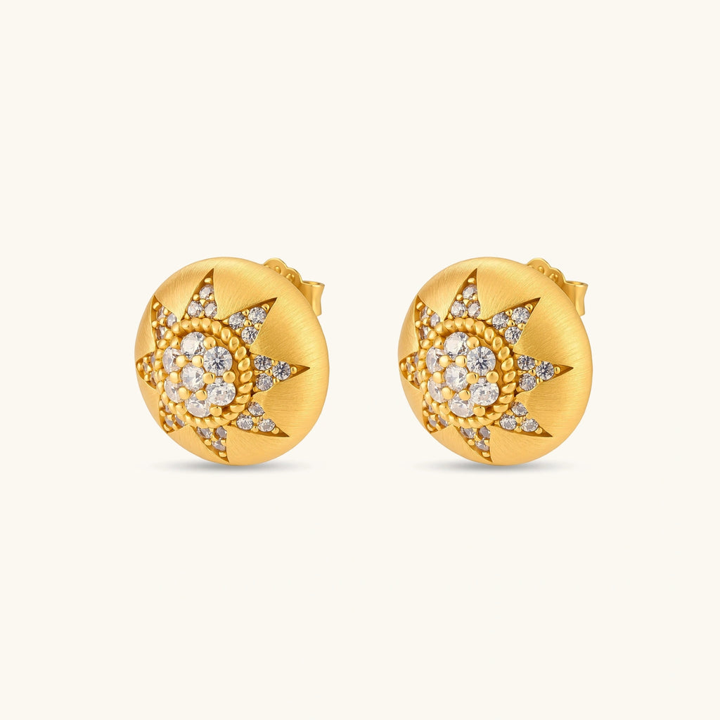 Round domed gold-plated stud earrings with brushed finish and an 8-point star paved in cubic zirconia stones.