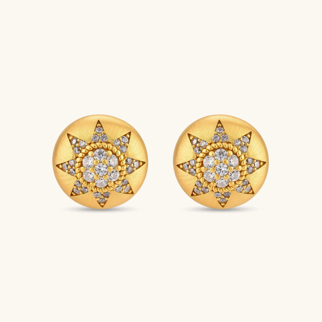 Round domed gold-plated stud earrings with brushed finish and an 8-point star paved in cubic zirconia stones.