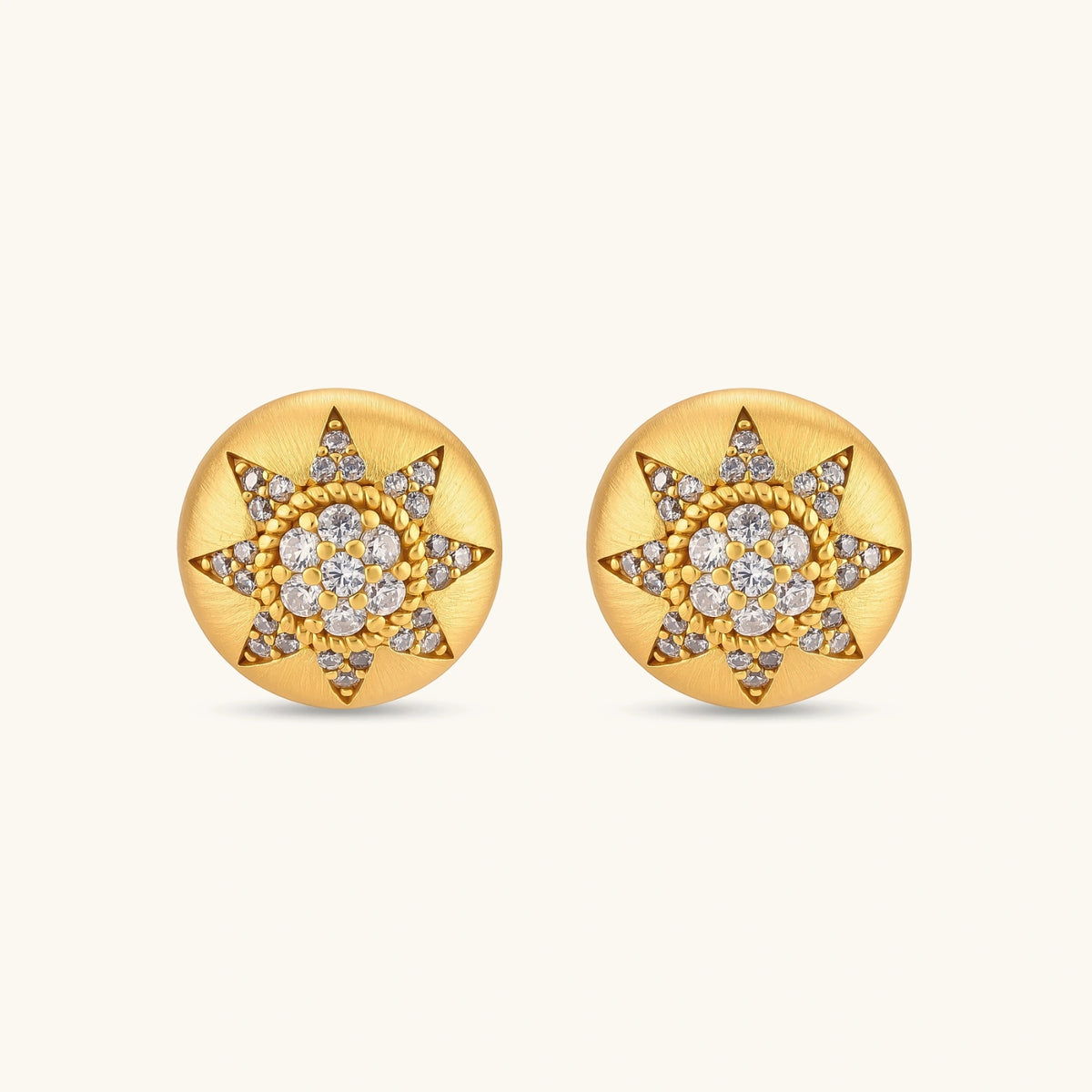 Round domed gold-plated stud earrings with brushed finish and an 8-point star paved in cubic zirconia stones.